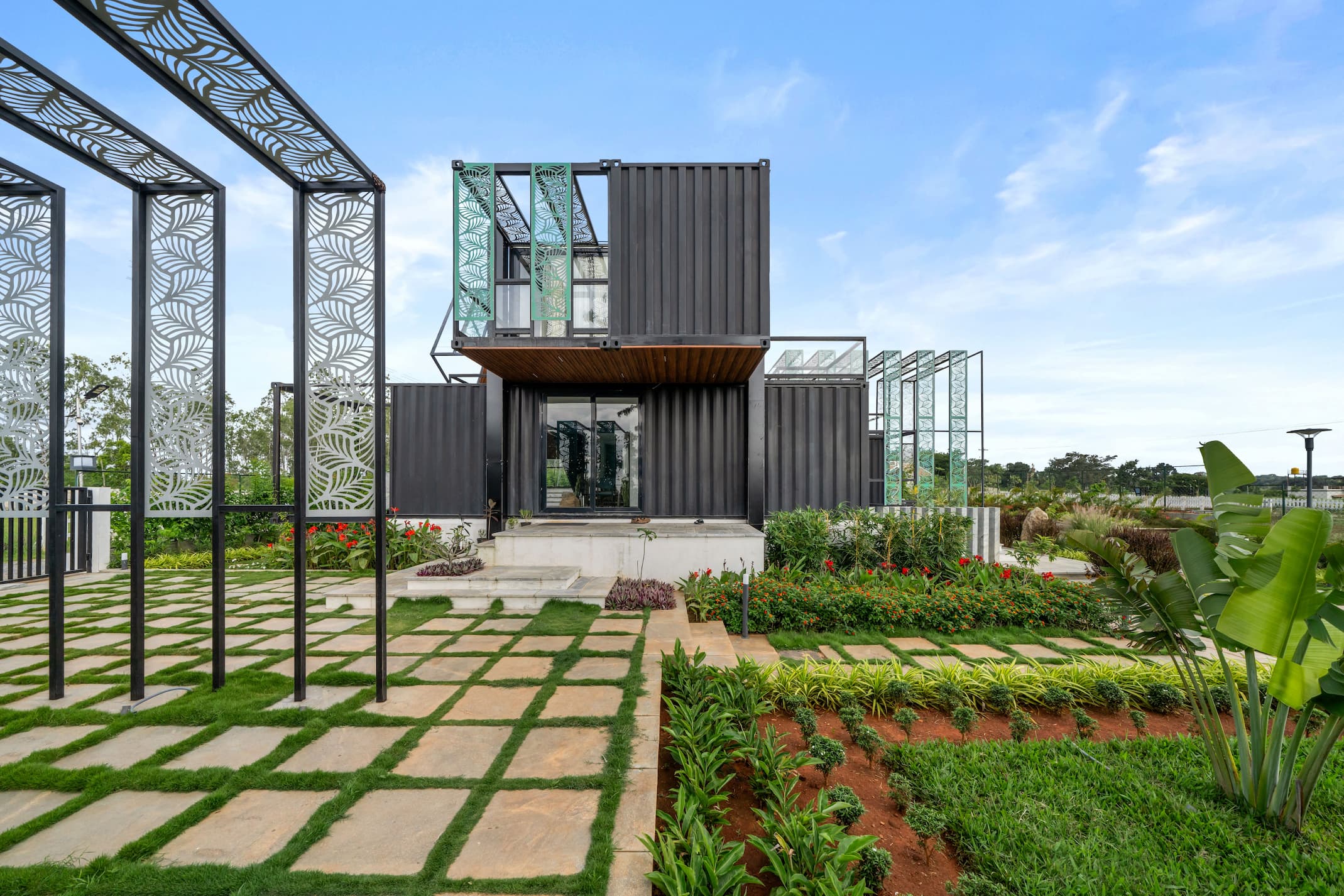 Daytime garden with stepping-stone path and laser-cut pergola archway